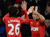 Manchester United's Mexican striker Javier Hernandez celebrates with Manchester United's Japanese midfielder Shinji Kagawa (L) after scoring an equalising goal during the English FA Cup third round tie on January 5, 2014
