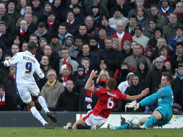 Tomasz Kuszczak (R) and Wes Brown of Manchester United are unable to stop Jermaine Beckford of Leeds United scoring the opening goal during the FA Cup 