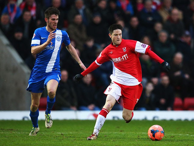 Kidderminster's Joe Lolley and Peterborough's Shaun Brisley in action during their FA Cup third round match on January 4, 2013