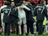 Leeds United manager Simon Grayson (C) celebrates with goalscorer, Leeds United's English forward Jermaine Beckford, after beating Manchester United 0-1 in their English FA Cup football match on January 3, 2010