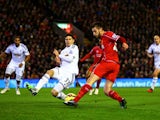 Adam Lallana of Liverpool crosses the ball under pressure from Federico Fernandez of Swansea City during the Barclays Premier League match between Liverpool and Swansea City at Anfield on December 29, 2014