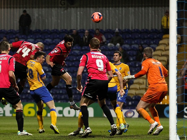 Matteo Lanzoni of Oldham heads home his team's third goal of the game during the FA Cup Second Round Replay match between Mansfield Town and Oldham Athletic at One Call Stadium on December 17, 2013