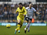 Michael O'Halloran of Tranmere Rovers is tackled by Gareth Roberts of Derby County during the FA Cup with Budweiser Third Round match between Derby County and Tranmere Rovers at Pride Park Stadium on January 5, 2013