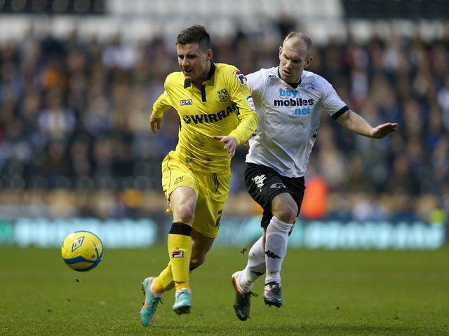 Michael O'Halloran of Tranmere Rovers is tackled by Gareth Roberts of Derby County during the FA Cup with Budweiser Third Round match between Derby County and Tranmere Rovers at Pride Park Stadium on January 5, 2013