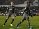 Jeff Schlupp of Leicester City celebrates his goal with Ritchie De Laet during the Sky Bet Championship match between Millwall and Leicester City at The Den on January 01, 2014