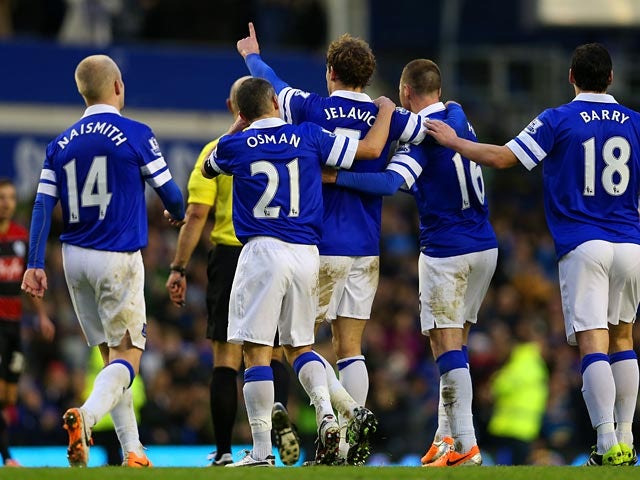 Everton's Nikica Jelavic celebrates with teammates after scoring his team's second goal against QPR during their FA Cup third round match on January 4, 2013