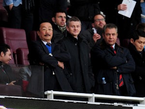 Molde manager Ole Gunnar Solskjaer and Cardiff City owner Vincent Tan look on from the stands prior to the Barclays Premier League match between Arsenal and Cardiff City at Emirates Stadium on January 1, 2014