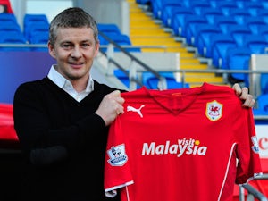 Ole Gunnar Solskjaer holds aloft the club shirt after being unveiled as the new Cardiff City Manager at Cardiff City Stadium on January 2, 2014