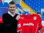 Ole Gunnar Solskjaer holds aloft the club shirt after being unveiled as the new Cardiff City Manager at Cardiff City Stadium on January 2, 2014