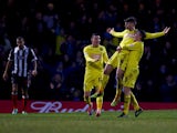 Huddersfield's Oliver Norwood celebrates with teammates after scoring his team's first goal against Grimsby during their FA Cup third round match on January 4, 2013