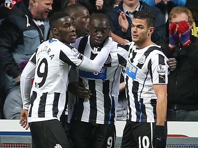 Newcastle's Papiss Cisse is congratulated by teammates after scoring the opening goal against Cardiff during their FA Cup third round match on January 4, 2013