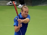 Germany's Peter Gojowczyk returns the ball to his countryman Dustin Brown during their tennis match in Qatar's ExxonMobil Open in Doha on January 2, 2014
