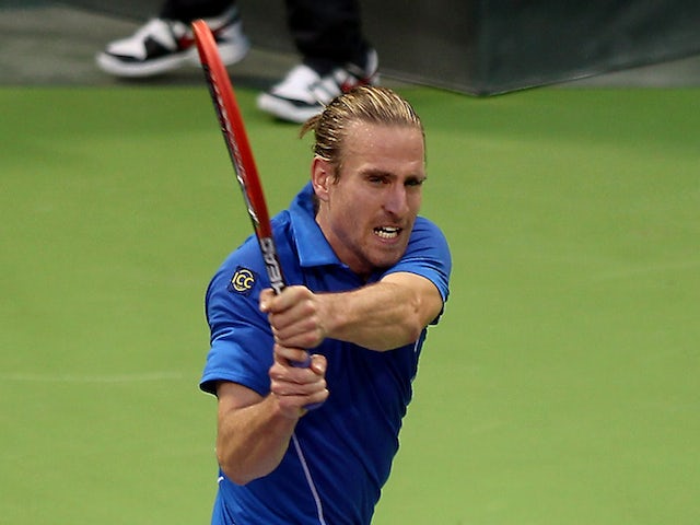 Germany's Peter Gojowczyk returns the ball to his countryman Dustin Brown during their tennis match in Qatar's ExxonMobil Open in Doha on January 2, 2014