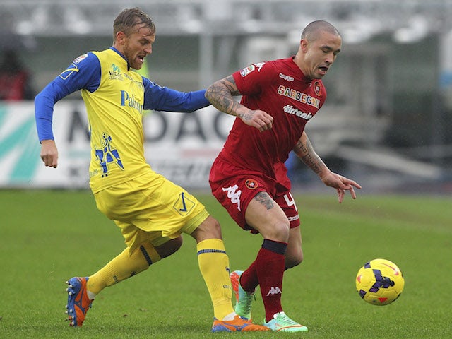 Radja Nainggolan (R) of Cagliari Calcio competes for the ball with Luca Rigoni (L) of AC Chievo Verona during the Serie A match on January 5, 2014