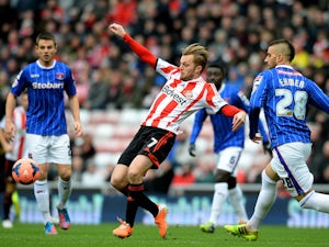Sebastian Larsson of Sunderland controls the ball iunder pressure from Max Ehmer of Calisle during the Budweiser FA Cup third round match on January 5, 2014