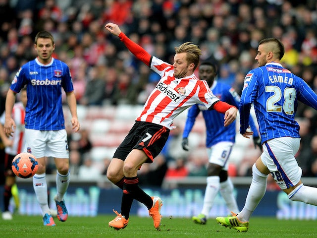 Sebastian Larsson of Sunderland controls the ball iunder pressure from Max Ehmer of Calisle during the Budweiser FA Cup third round match on January 5, 2014