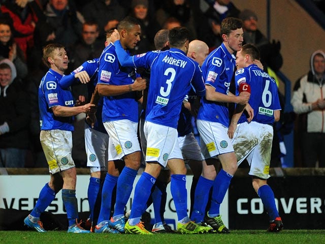 Macclesfield's Steve Williams is mobbed by teammates after scoring his team's opening goal against Sheffield Wednesday during their FA Cup third round match on January 4, 2013