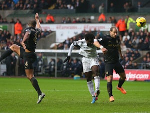 Wilfried Bony of Swansea City scores his sides opening goal as Pablo Zabaleta of Manchester City fails to challenge during the Barclays Premier League match between Swansea City and Manchester City at the Liberty Stadium on January 1, 2014