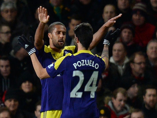 Swansea City's English midfielder Wayne Routledge (2R) celebrates with Swansea City's Spanish midfielder Alejandro Pozuelo (R) after scoring the opening goal against Manchester United on January 5, 2014