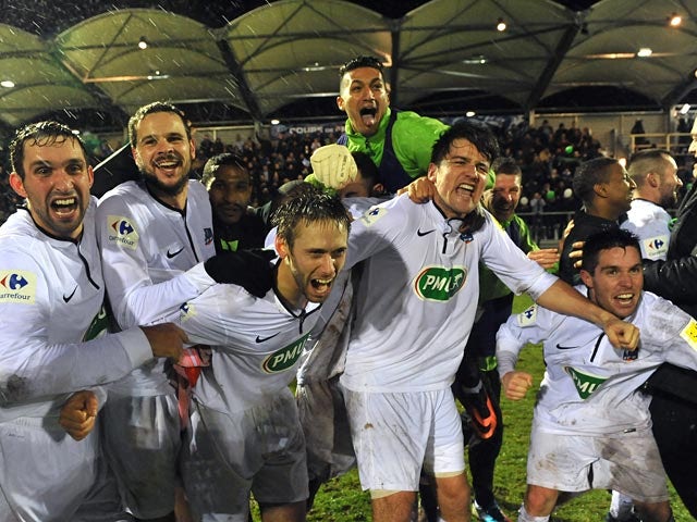 Yzeure players celebrates victory over Lorient after the final whistle during their French Cup match on January 4, 2013