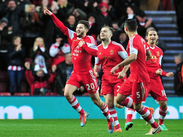 Southampton's English midfielder Adam Lallana (L) celebrates scoring the opening goal of the English Premier League football match between Southampton and West Bromwich Albion on January 11, 2014