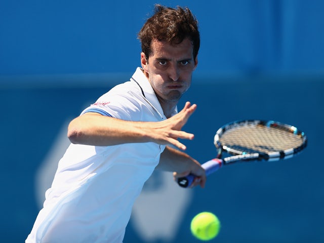 Albert Ramos of Spain plays a forehand in his qualifying match against Blaz Kavcic of Slovenia during day two of the Sydney International at Sydney Olympic Park Tennis Centre on January 6, 2014