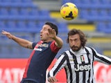 Cagliari's Andrea Cossu and Juventus' midfielder Andrea Pirlo battle for the ball during their Serie A match on January 12, 2014