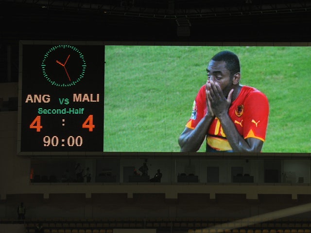 Angola's Zuela is shown on a big screen as he reacts to the 4-4 draw the Group A African Nations Cup match between Angola and Mali, at the November 11 Stadium on January 10, 2010