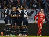 Marseille's Benoit Cheyrou is congratulated by teammates after scoring his team's first goal against Evian during their Ligue 1 match on January 12, 2014