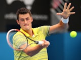Bernard Tomic of Australia plays a forehand in his first round match against Marcel Granollers of Spain during day three of the 2014 Sydney International at Sydney Olympic Park Tennis Centre on January 7, 2014