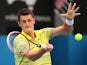 Bernard Tomic of Australia plays a forehand in his first round match against Marcel Granollers of Spain during day three of the 2014 Sydney International at Sydney Olympic Park Tennis Centre on January 7, 2014