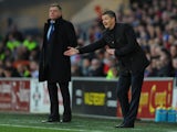 New Cardiff manager Ole Gunnar Solskjaer reacts as Sam Allardyce looks on during the Barclays Premier League match between Cardiff City and West Ham United at Cardiff City Stadium on January 11, 2014