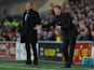 New Cardiff manager Ole Gunnar Solskjaer reacts as Sam Allardyce looks on during the Barclays Premier League match between Cardiff City and West Ham United at Cardiff City Stadium on January 11, 2014