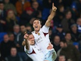 Mark Noble celebrates with Andy Carroll of West Ham United after scoring his sides second goal duering the Barclays Premier League match between Cardiff City and West Ham United at the Cardiff City Stadium on January 11, 2014