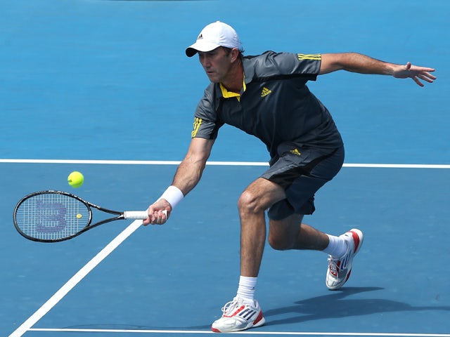 Darren Cahill of Australia plays a shot in his second round legends doubles match with Mats Wilander of Sweden against Jacco Eltingh of the Netherlands and Paul Haarhuis of the Netherlands during day nine of the 2013 Australian Open at Melbourne Park on J