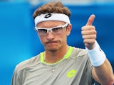 Dennis Istomin of Uzbekistan celebrates victory in his second round match against Marin Cilic of Croatia during day four of the 2014 Sydney International on January 8, 2014