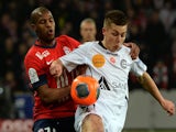 Lille's French defender Dijbril Sidibe vies with Reims' forward Nicolas de Preville during the French L1 football match Lille vs Reims, on January 12, 2014