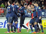 Paris Saint-Germain's Argentine forward Ezequiel Lavezzi celebrates with teammates after scoring his team's fifth goal during the French League Cup football match against Brest on January 8, 2014