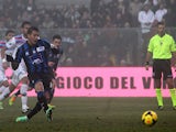 Atalanta's German Denis scores his team's first goal via the penalty spot against Calcio Catania during their Serie A match on January 12, 2014