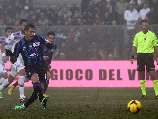 Atalanta's German Denis scores his team's first goal via the penalty spot against Calcio Catania during their Serie A match on January 12, 2014