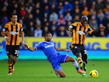 Ashley Cole of Chelsea tackles Yannick Sagbo of Hull City during the Barclays Premier League match between Hull City and Chelsea at KC Stadium on January 11, 2014