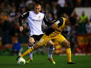 Jeremy Mathieu (L) of Valencia competes for the ball with Diego Costa of Atletico de Madrid during the Copa del Rey round of 16 first leg match on January 7, 2014