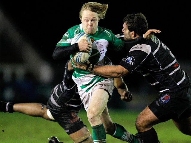 Newcastle Falcons' Joel Hodgson is tackled by Brive's Apisai Naikatini and Johannes Coetzee during their Challenge Cup match on January 9, 2014