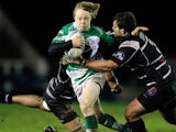 Newcastle Falcons' Joel Hodgson is tackled by Brive's Apisai Naikatini and Johannes Coetzee during their Challenge Cup match on January 9, 2014