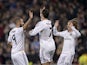 Real's Karim Benzema celebrates with teammates Cristiano Ronaldo and Luka Modric after scoring the opening goal against Osasuna during their Copa del Rey match on January 9, 2014