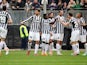 Juventus' Llorente is congratulated by teammates after scoring his team's first goal against Cagliari during their Serie A match on January 12, 2014