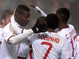 Mario Balotelli of AC Milan celebrates with team-mates after scoring their first goal during the Serie A match between US Sassuolo Calcio and AC Milan on January 12, 2014