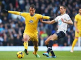 Marouane Chamakh of Crystal Palace holds off Nabil Bentaleb of Tottenham Hotspur during the Barclays Premier League match on January 11, 2014