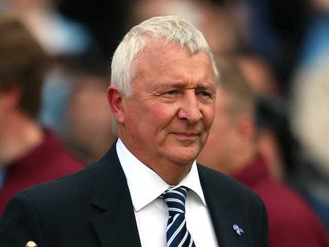 Mike Summerbee brings out the Barclays Premier League trophy following the Barclays Premier League match between Manchester City and QPR on May 13, 2012