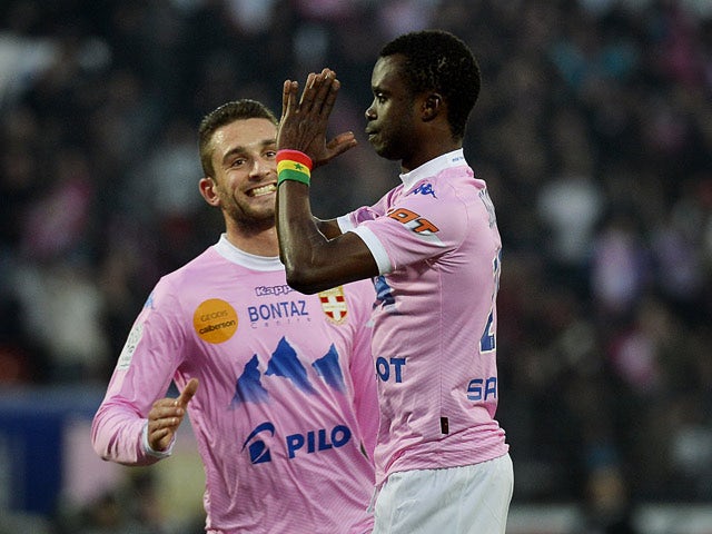 Evian's Modou Sougou celebrates after scoring the opening goal against Marseille during their Ligue 1 match on January 12, 2014